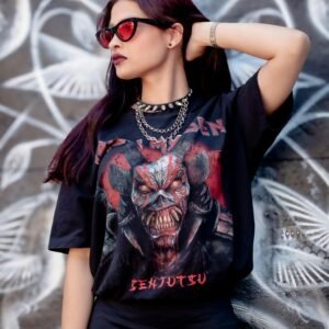 Stylish woman in sunglasses with graphic tee poses against a vibrant graffiti backdrop.
